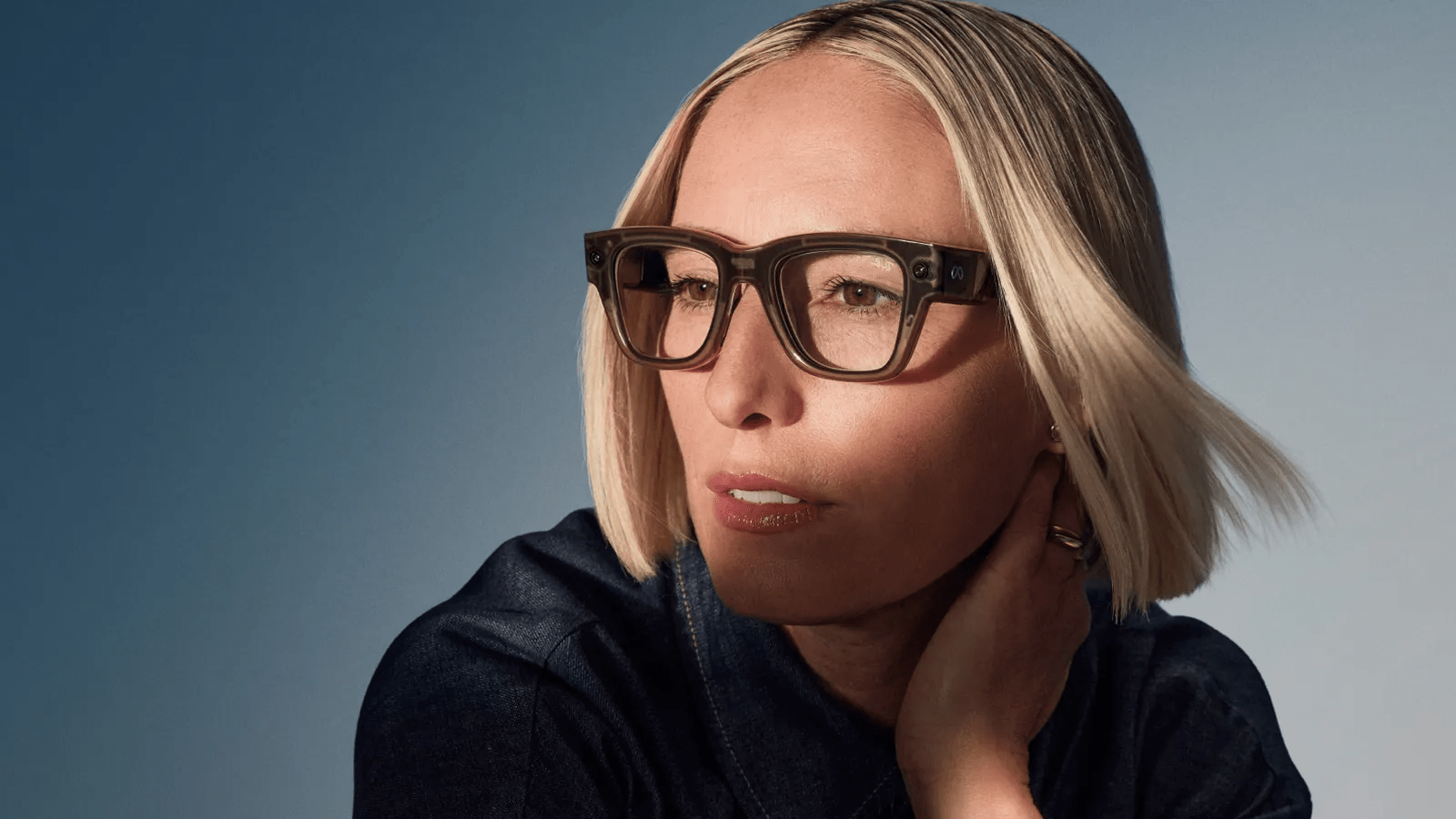 Model wearing Meta Ray-Ban Display smart glasses with neural band.