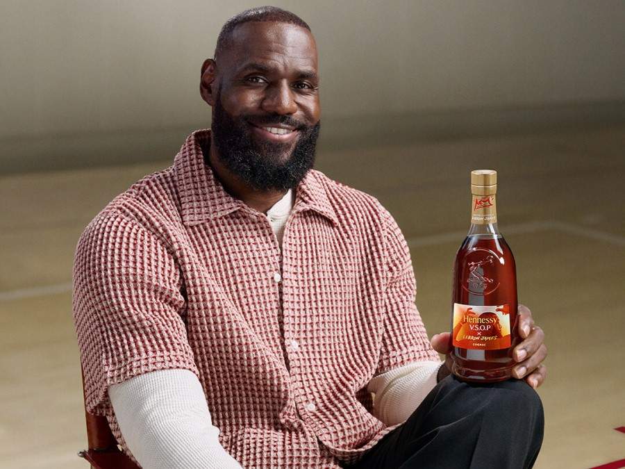 Lebron James smiles with a bottle of his 2025 Hennessy VSOP