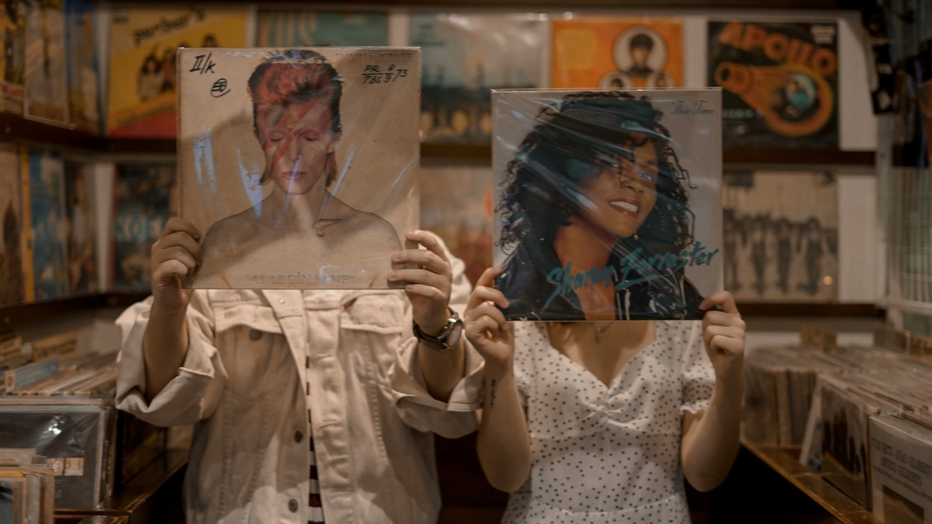 Image of two people holding vinyl records for Record Store Day Black Friday 2025
