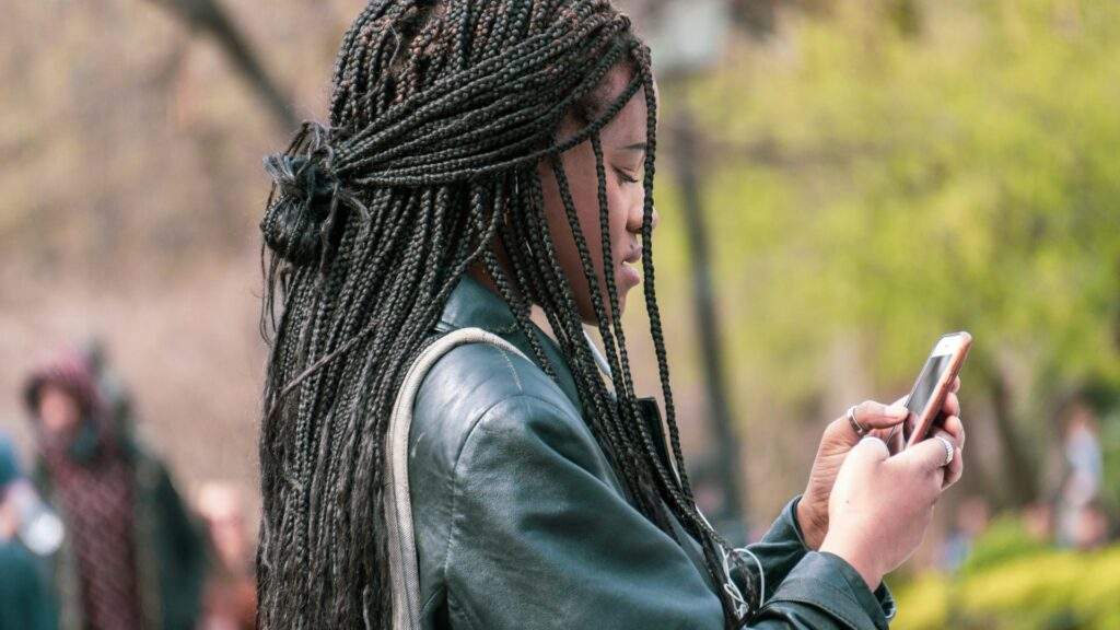 Woman checking her phone for sold eBay listings